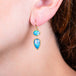 Ethiopian opal earrings on a model