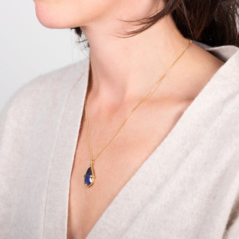 Tanzanite teardrop necklace on a model side view