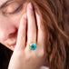 Oval turquoise ring on a model side view
