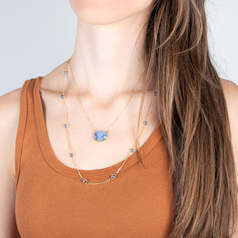 london blue topaz whisper chain necklace and blue elephant on model