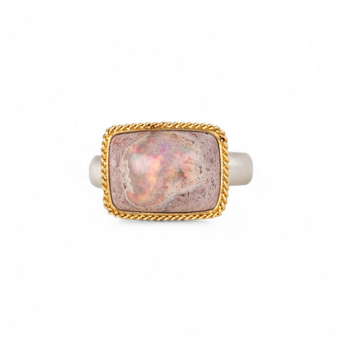 Handcrafed ring featuring a mexican opal gemstone in an 18k gold setting with a sterling silver band