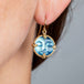 Carved moon face earrings on model