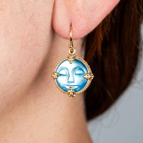 Carved moon face earrings on model different angle