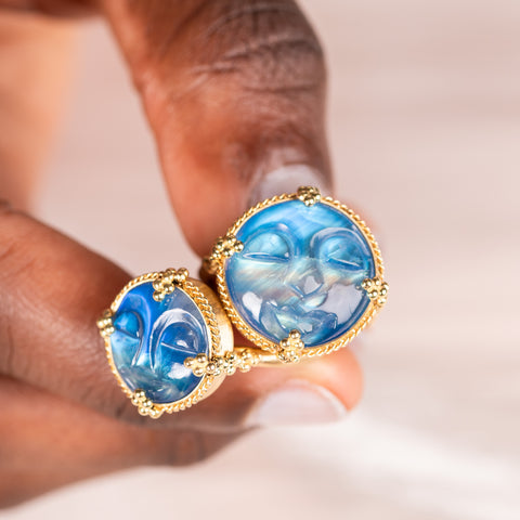 Moonstone face rings held in hand