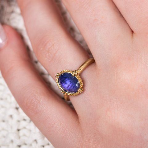 Oval tanzanite ring on white on model