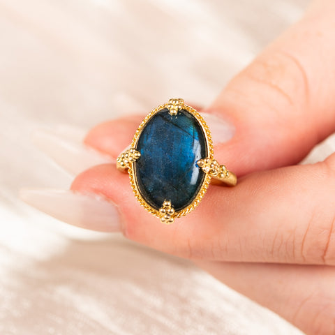 Oval labradorite ring held in hand