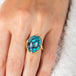 Turquoise and gold ring on model