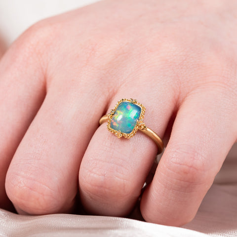 Petite ethiopian opal ring on model
