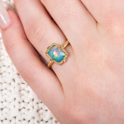Petite ethiopian opal ring on model
