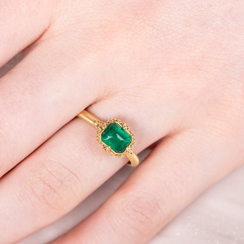 Petite emerald ring on model close up
