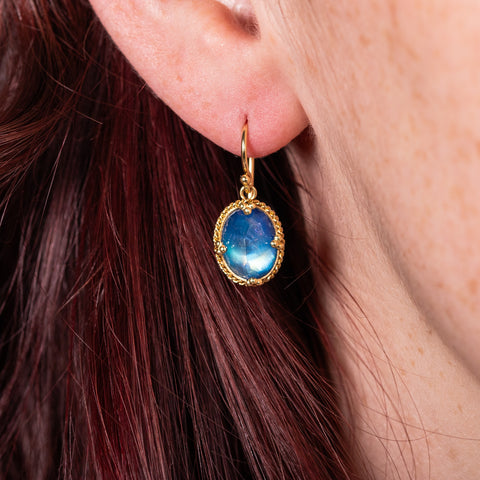 Petite oval moonstone earrings on model