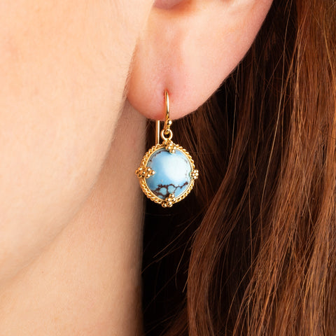 Round Turquoise earrings on a model