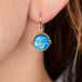 Carved moonstone earring on model
