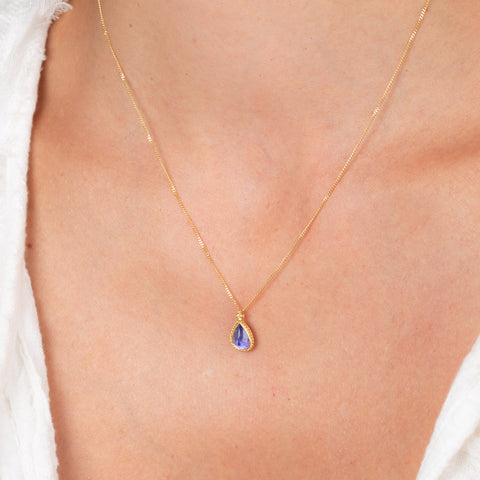 Petite tanzanite necklace on model 