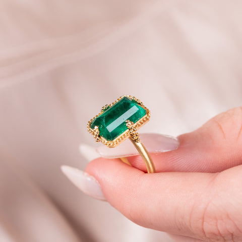 Emerald ring held in hand