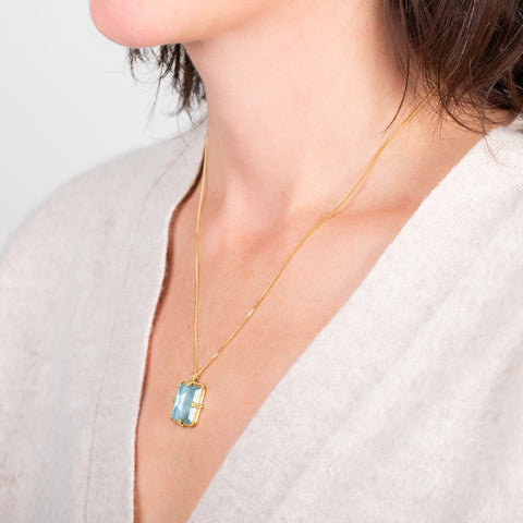 Rectangular aquamarine necklace on a model side view