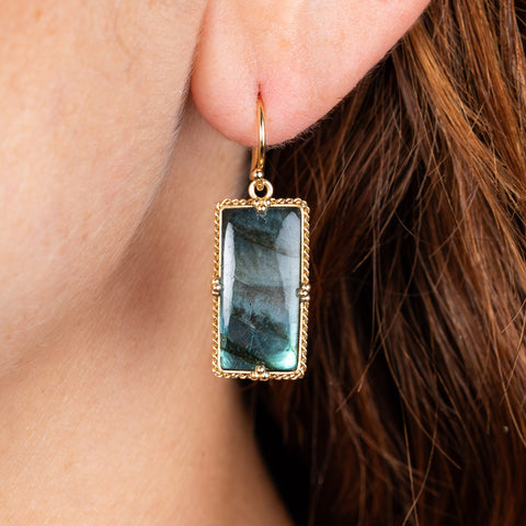 rectangular labradorite earrings on model close up