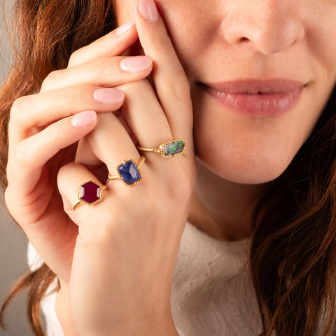 Tanzanite ring paired with ruby and boulder opal rings