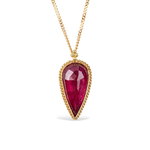 Ruby and gold necklace on white