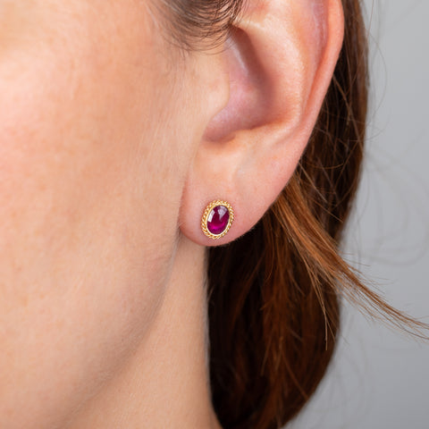 Ruby and gold stud earrings on model