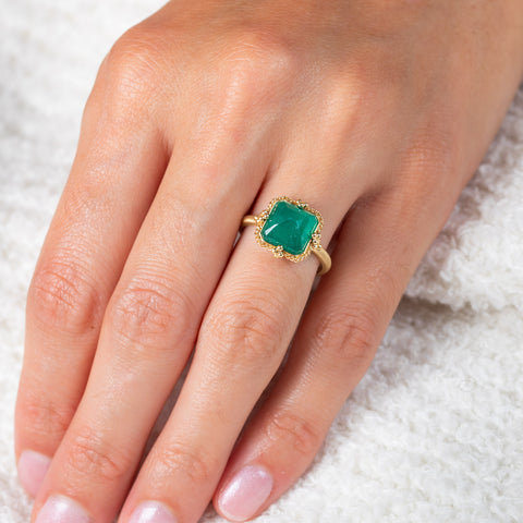 Emerald and gold ring on model