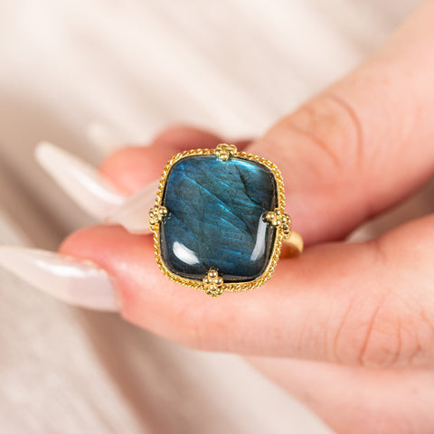 Square labradorite ring held in hand