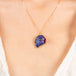 Carved tanzanite parrot necklace on a model.