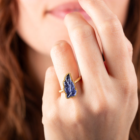 Carved tanzanite leaf ring on a model