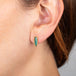 Tourmaline and gold stud earrings on model