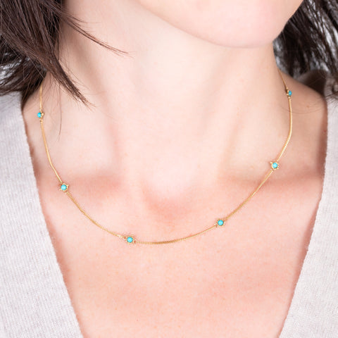 Textile turquoise necklace on a model close up