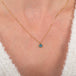 Tiny opal heart necklace on model