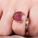 Carved tourmaline parrot ring on model close up