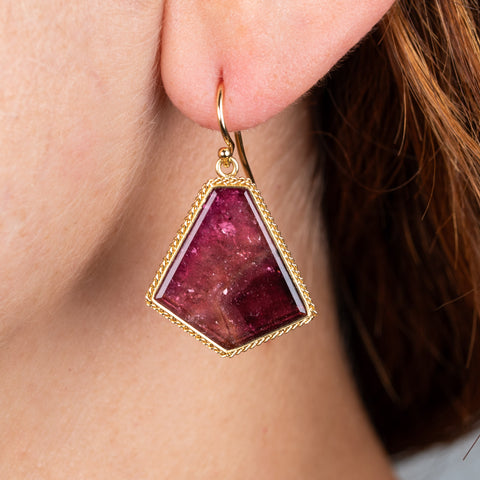 Tourmaline and gold earrings on model