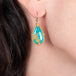 Turquoise teardrop earrings on a model