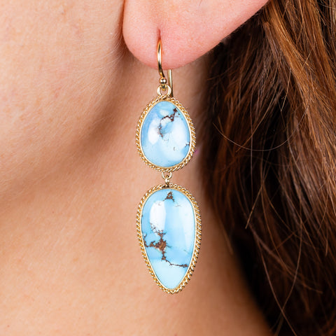 Turquoise drop earrings on model close up