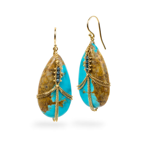 Draped turquoise earrings adorned with blue diamonds.