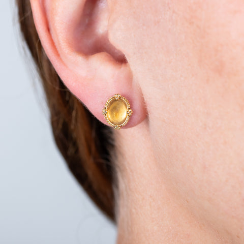 Yellow Sapphire stud earrings on a model