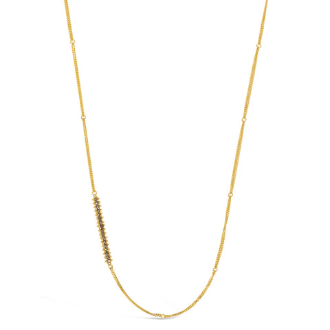 This long gold chain features a row of woven champagne diamonds beads stationed off-center. The necklace is finished with a lobster clasp