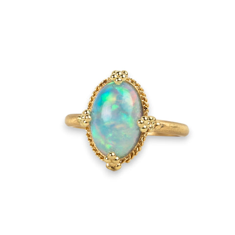 Ethiopian Opal ring in 18K yellow gold, displaying a stunning display of colorful confetti. Encased in a meticulously handmade gold frame with braided gold and granulation.