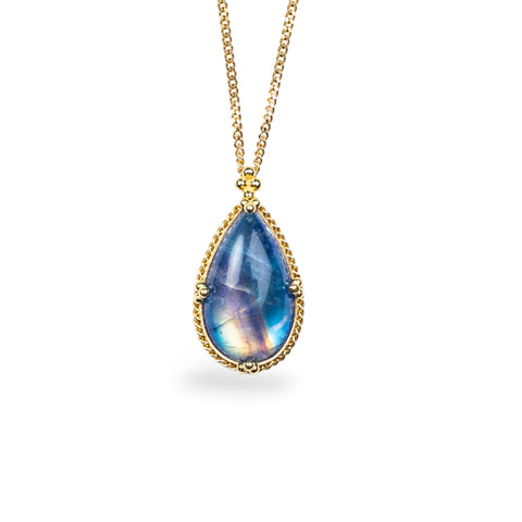Teardrop Moonstone pendant on an 18K yellow gold chain. Encased in a handmade gold bezel with braided detail. Handmade in New York.