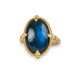 Labradorite ring in 18K yellow gold, featuring an iridescent deep cerulean blue wash, reminiscent of ocean depths. The gemstone held in a gold setting with braided detail and granulated prongs. 