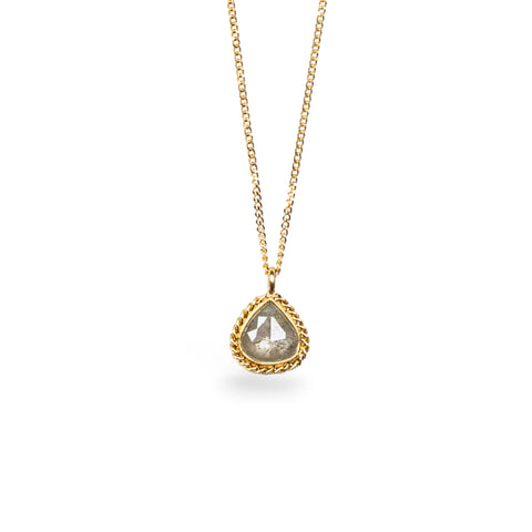 Pear-shaped Diamond pendant on an 18K yellow gold chain. Set in a handmade gold bezel with braided detail. Handmade in New York.