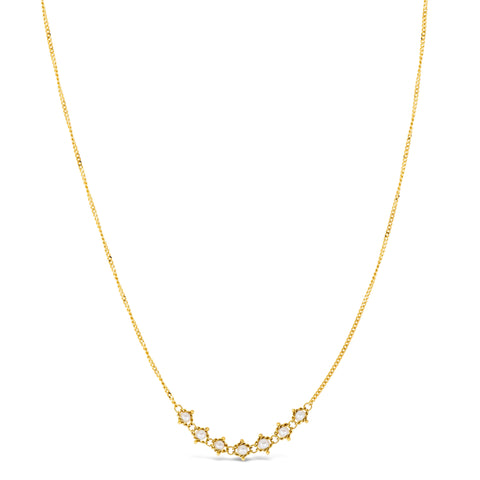 This delicate 18k yellow gold necklace features a row of seven woven pearl beads in the center. The necklace is finished with a lobster clasp closure