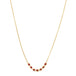 This delicate 18k yellow gold necklace features a row of seven woven ruby beads in the center. The necklace is finished with a lobster clasp closure