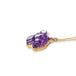 An amethyst panther pendant on an 18K yellow gold chain. Handmade gold bezel showcases intricate braided detail. 