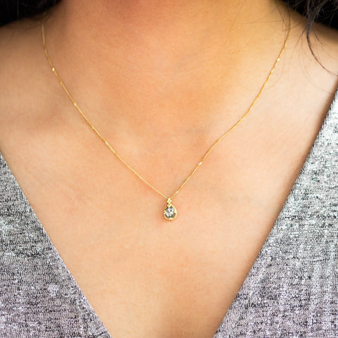 Salt and pepper diamond necklace on an 18k yellow gold chain on model
