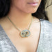 Sand rose carved owl necklace on neck
