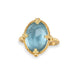 Aquamarine ring in 18K yellow gold, with shades of blue and aqua dancing beneath the surface in the light. Set in a handmade gold frame with braided gold accents and granulated prongs.