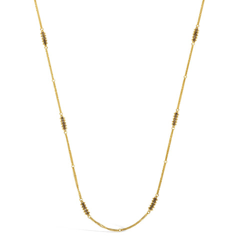 This 18k yellow gold chain necklace features rows of champagne diamond stations woven throughout the necklace. The piece is finished with a lobster clasp closure.