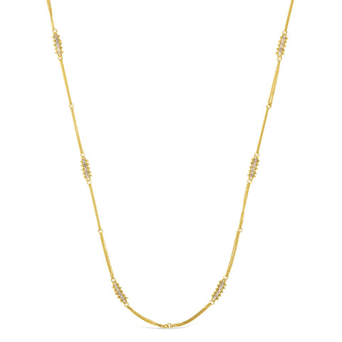 This 18k yellow gold chain necklace features rows of silver diamond stations woven throughout the necklace. The piece is finished with a lobster clasp closure.